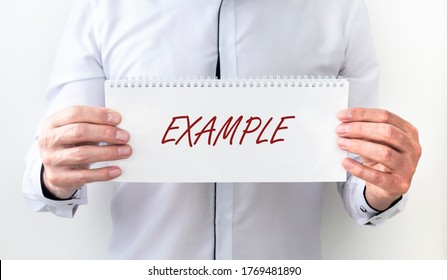 Example Word Handwritten On Paper In Male Hands. Business Example Concept