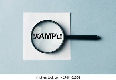 Example Word Inscription On Paper Note Through Magnifier. Example Concept. Searching For Example, Explore Examples