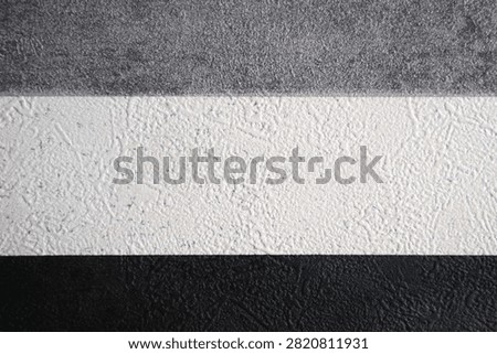 Examples of decorative wall textures (stucco) in three color variations, gray, white, and black. Textured finishes like this are typically used to add aesthetic dimension to building exteriors or interior walls.