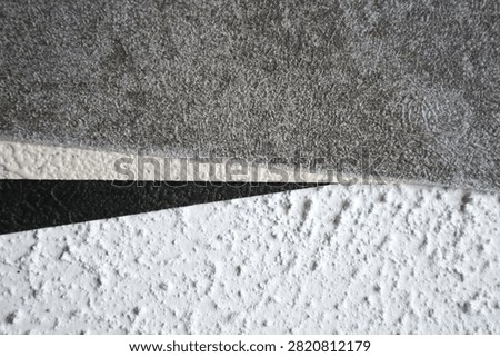 Examples of decorative wall textures (stucco) in three color variations, gray, white, and black. Textured finishes like this are typically used to add aesthetic dimension to building exteriors or interior walls.