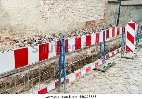 of excavated\
walk with Construction\
Barrier