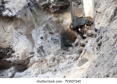 excavating earth-moving digger close up with hydraulic bucket and boom. digging a hole in sand - Shutterstock ID 793507540