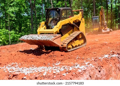 Excavation at a construction site, mini loader bobcat transports crushed stone to different construction places - Shutterstock ID 2157794183