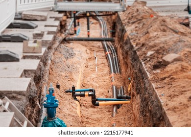 Excavation Trench On A City Street To Replace Plastic Water Pipes Or Laying Cables. Repair And Renovation At Construction And Development Site.