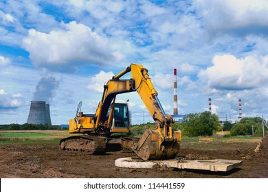 Excavator against the dark blue sky - Shutterstock ID 114441559