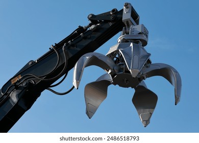 Excavator arm with metal scrap grabber. Excavator orange peel grapple. - Powered by Shutterstock