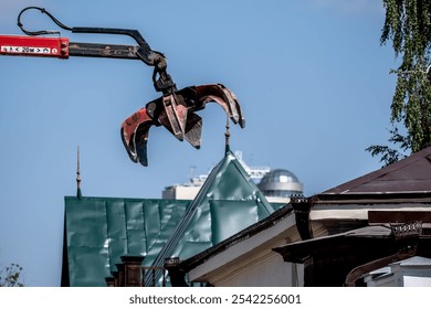 An excavator bucket with paws for capturing debris in the air. - Powered by Shutterstock