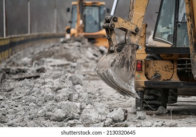 An excavator bulldozer truck working construction site for road asphalt renovation bridge  Demolition the old layers road 