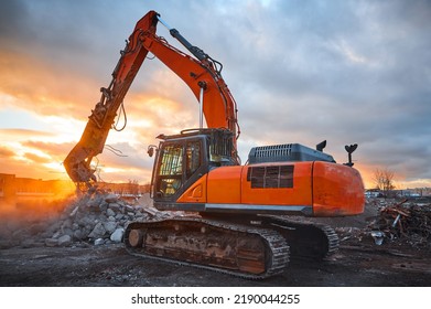Excavator with concrete crusher on rig at demolition site