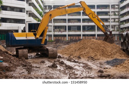 Excavator Construction Equipment Park At Worksite.