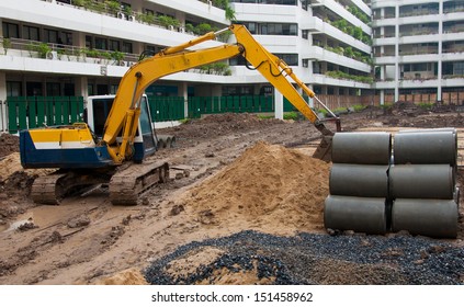 Excavator Construction Equipment Park At Worksite.