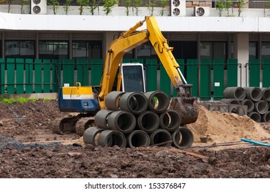 Excavator Construction Equipment Park At Worksite.