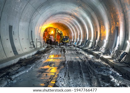 Excavator in construction place of building new railway tunnel. Railway corridor construction with machinery.