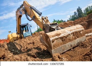 Excavator at Construction Site - digging foundations for house - Shutterstock ID 1106727281