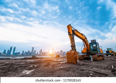 excavator in construction site sunset sky background
