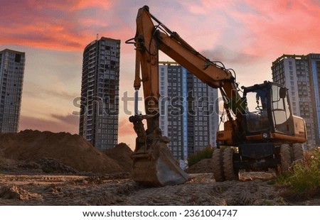 Excavator dig ground at construction site. Dig foundation. Construction of residential buildings and renovation. Earthmover on groundwork. Excavator on earthmoving. Loader on dredging and trenching.