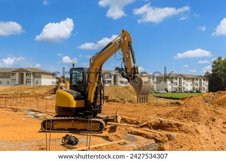 Excavator dig trenches at construction site during earthmoving works preparing infrastructure area