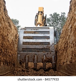 Excavator Digging A Deep Trench