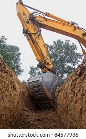 Excavator Digging A Deep Trench