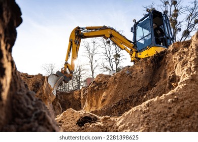 Excavator digging a hole into the ground