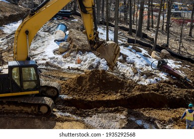 Excavator Is Digging A Huge Trench, Ditch For Drainage Canal Utility Pipe Pipeline Installation At Construction Site.