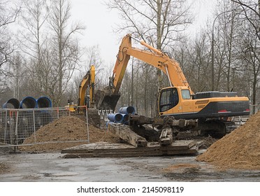 Excavator Digs A Hole For Laying Water Pipes. Replacement Of The City Water Supply Network.