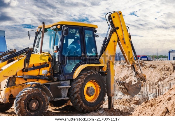Excavator digs piles. Earthworks for the\
construction of the foundation. Construction equipment for the\
device of piles. Preparatory work for\
grillage