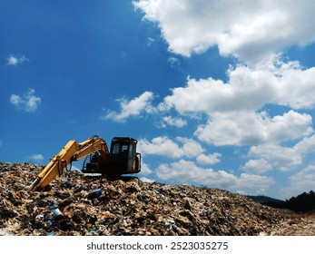 An excavator is dredging up rubbish at a rubbish dump during the day - Powered by Shutterstock