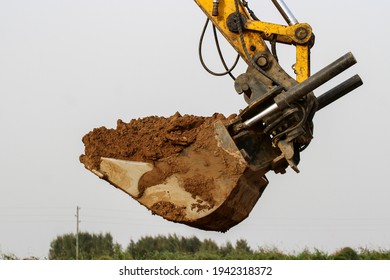 Excavator During Construction New Road In Forest Area. Yellow Backhoe At Groundwork.