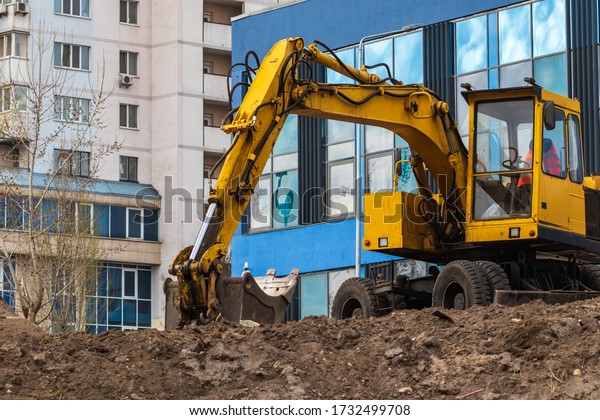 Excavator loader during earthworks at a\
construction site. The excavator is on the construction of a new\
park area. Excavator without a\
driver.