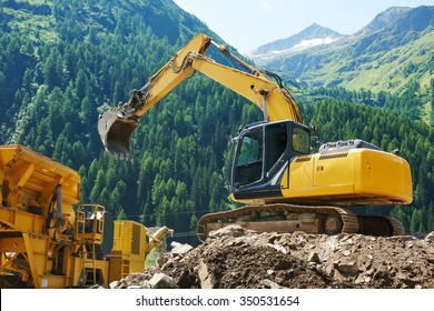 Excavator Loader Machine Loading Dumper Truck At Construction Site