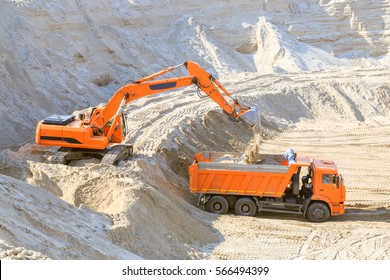 Excavator Loading Dumper Truck With Sand At A Sand Quarry