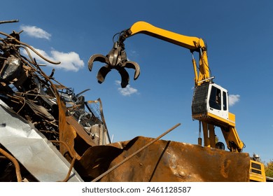 Excavator for loading scrap metal. Selective focus. - Powered by Shutterstock