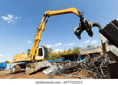 Excavator for loading scrap metal. Selective focus. - Powered by Shutterstock