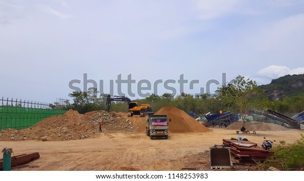  excavator loading\
stone  ,sand, construction, railways in Prachuap Khiri Khan,\
Thailand July 31, 2018.   
