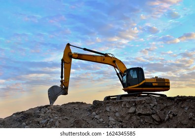 Excavator Loads Of Stone And Rubble For Processing Into Cement Or Concrete For Construction Work And Reuse. Backhoe At Quarry. Develop The Glavel Stone Or Aggregate, Sand, Gravel, And Prismatic Blocks