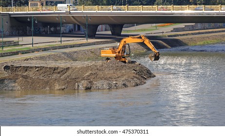 Excavator Machine Digging Levee at River Embankment - Shutterstock ID 475370311