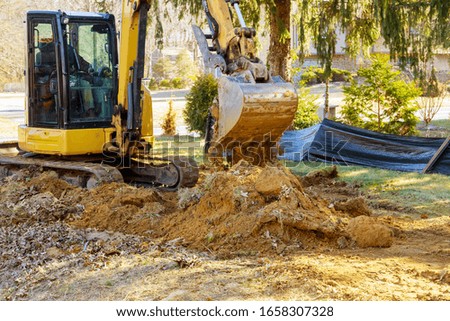 Excavator machine unloading soil earth moving construction works