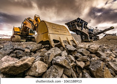 Excavator and machinery in an outdoor mine