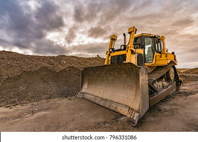 Excavator making earth movements for the construction of a road