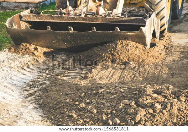 Excavator moving earth with the shovel on the\
construction site
