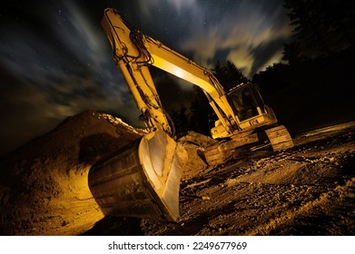 Excavator at night, dramatic lighting and composition, with clouds and stars in the sky in background