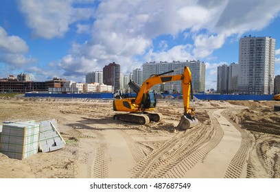 The excavator on building of the new house. Construction of a house