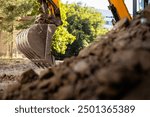 Excavator on construction site. Backhoe digging soil for construction business.