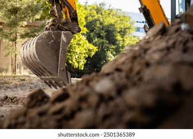 Excavator on construction site. Backhoe digging soil for construction business.