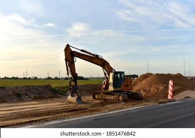 Excavator On Earthworks And Road Construction In City. Temporary Traffic Regulation From Carrying Out Road Works Or Activity On The Public Highway. Roadway Work Zone Safety. Out Of Focus, Motion Blur