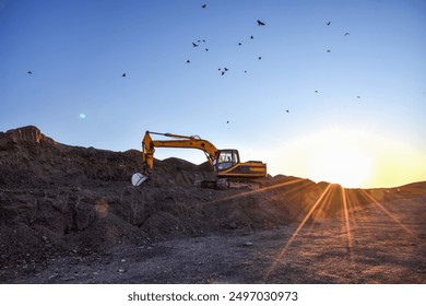 Excavator on sunset background. Open-pit mining. Backhoe dig ground in quarry. Heavy construction equipment on excavation on construction site. Excavator on groundwork on dramatic twilight.  - Powered by Shutterstock