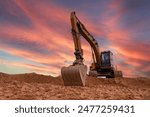 Excavator on sunset. Open-pit mining. Backhoe dig ground in quarry. Heavy construction equipment on excavation on construction site. Excavator on groundwork on dramatic twilight. Groundworks.