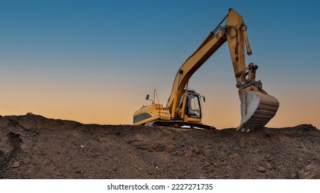 Excavator in open pit mining. Excavator on earthmoving on sunset. Loader on excavation. Earth-Moving Heavy Equipment. Earth mover ar construction site. Backhoe Loader on Road construction.  - Shutterstock ID 2227271735