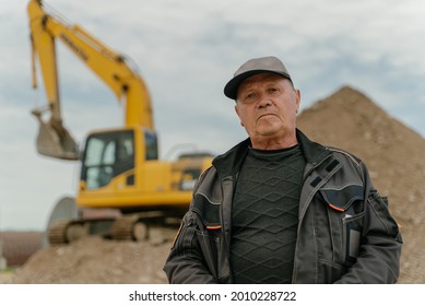 The Excavator Operator Stands In Front Of The Excavator.